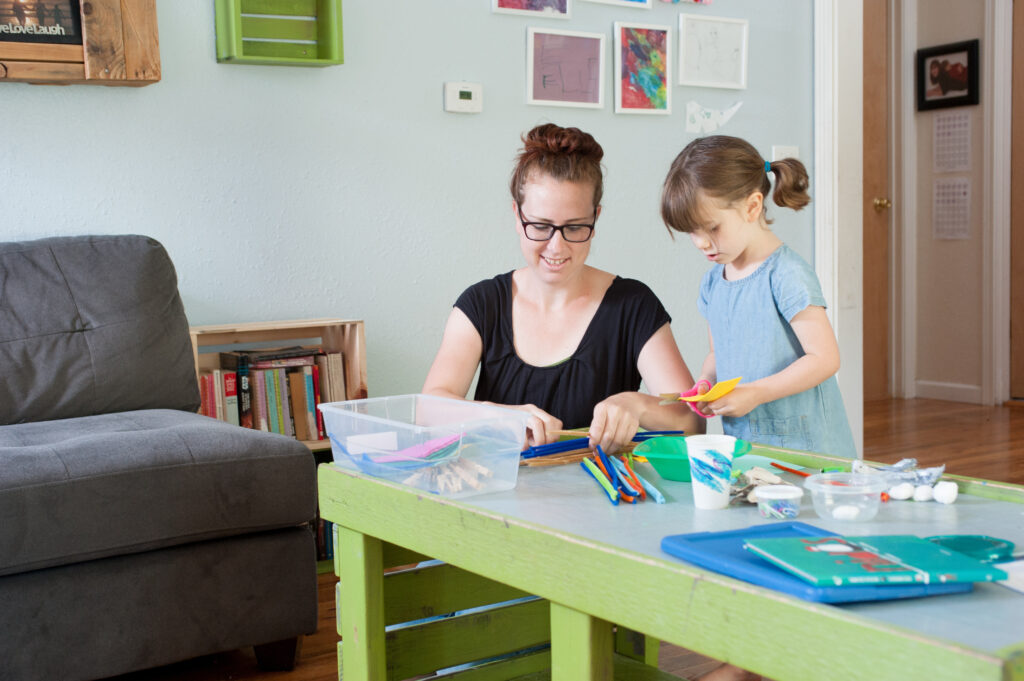 Child and Adult Doing an Activity Kit