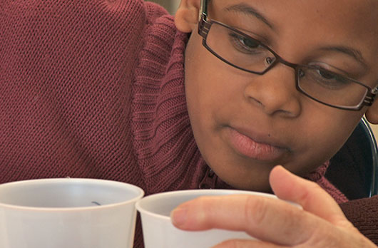 Student Studies Cup Up Close